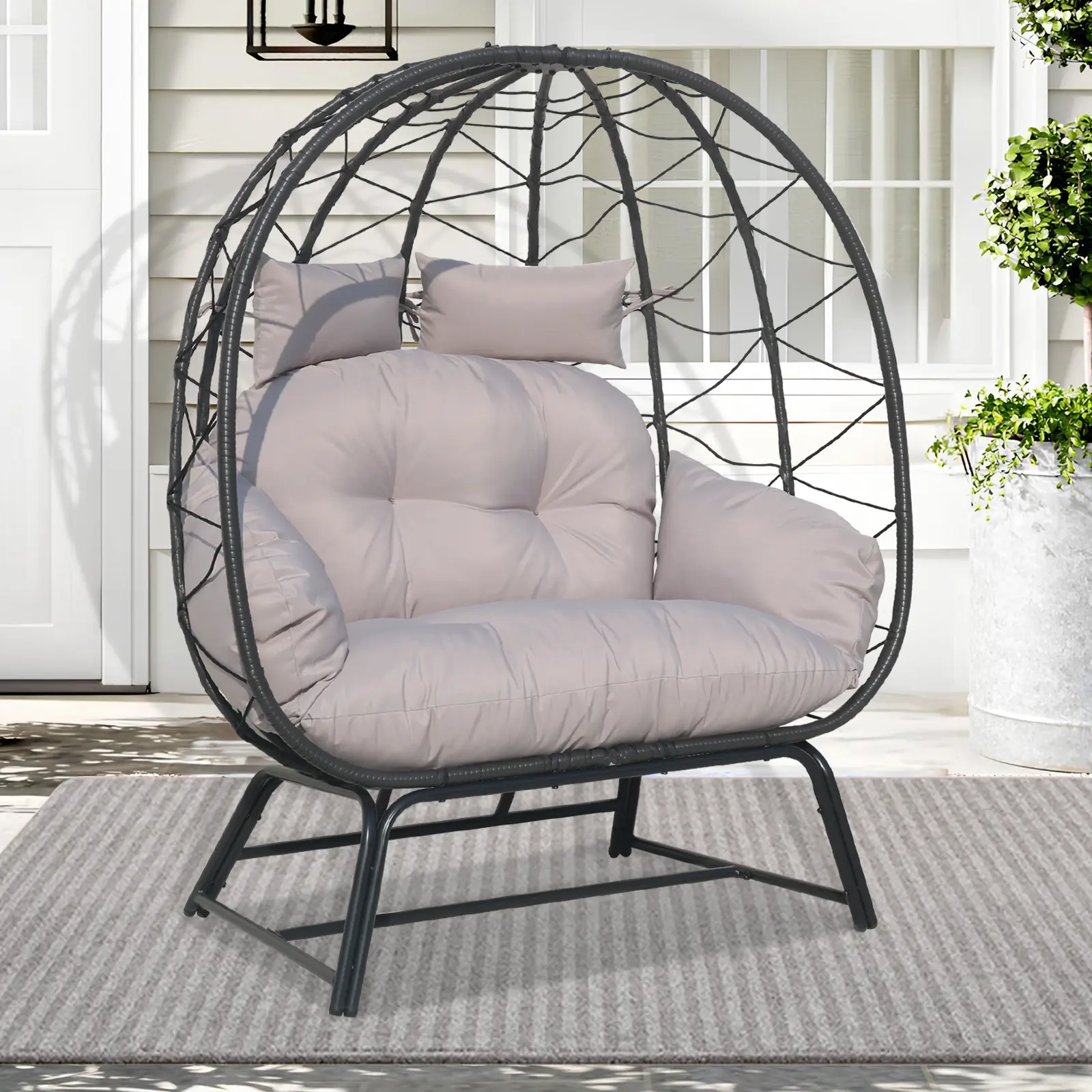 Woven egg chair displayed in a styled outdoor patio scene