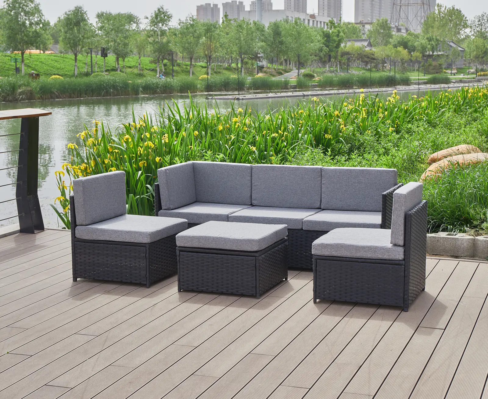 Premium outdoor lounge furniture arranged on a wood deck near the water